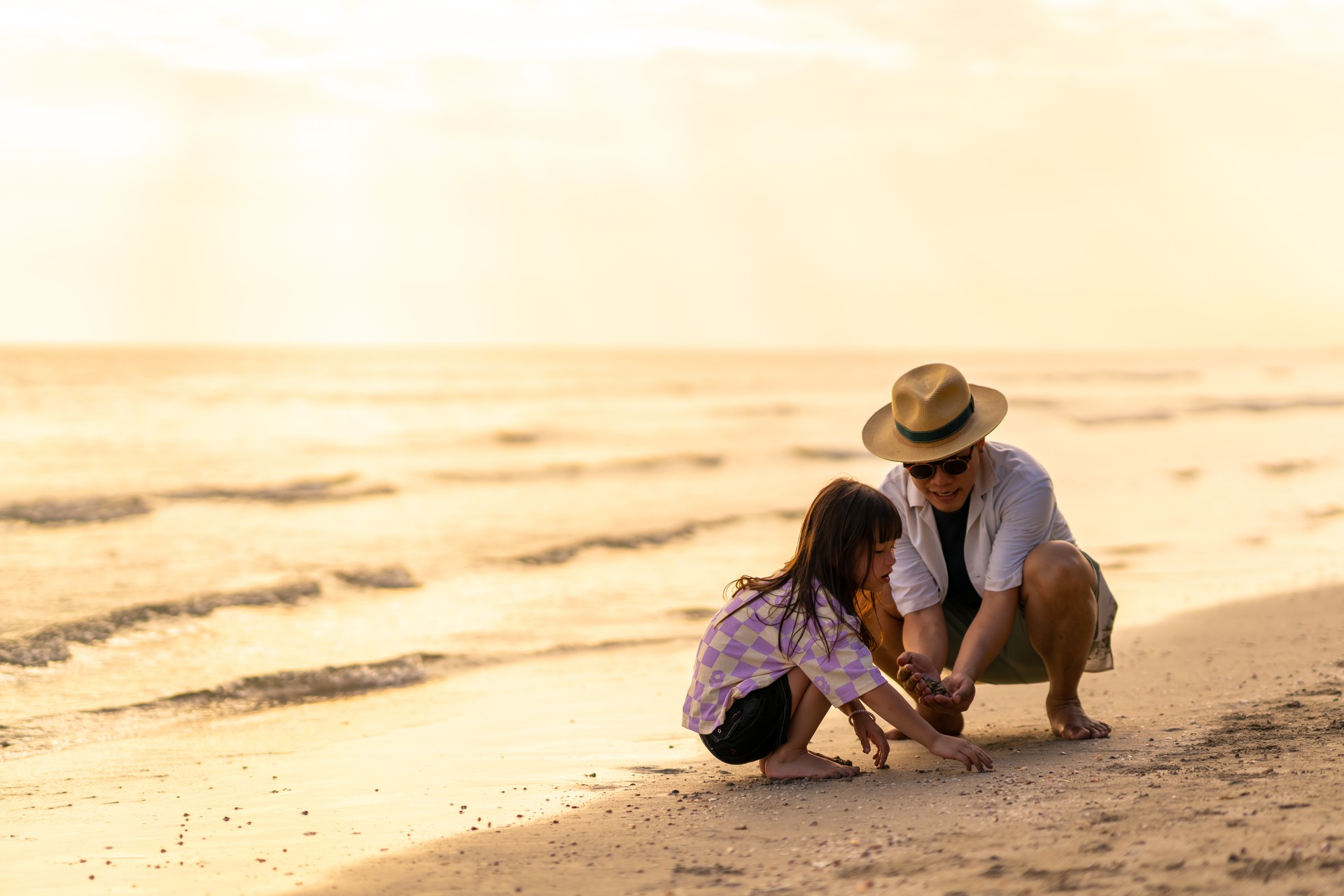 Asian family playing together at the sea.